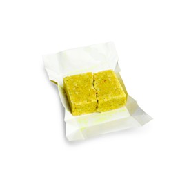 Photo of Unwrapped bouillon cube on white background. Broth concentrate