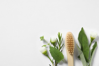 Photo of Flat lay composition with toothbrush and herbs on white background. Space for text