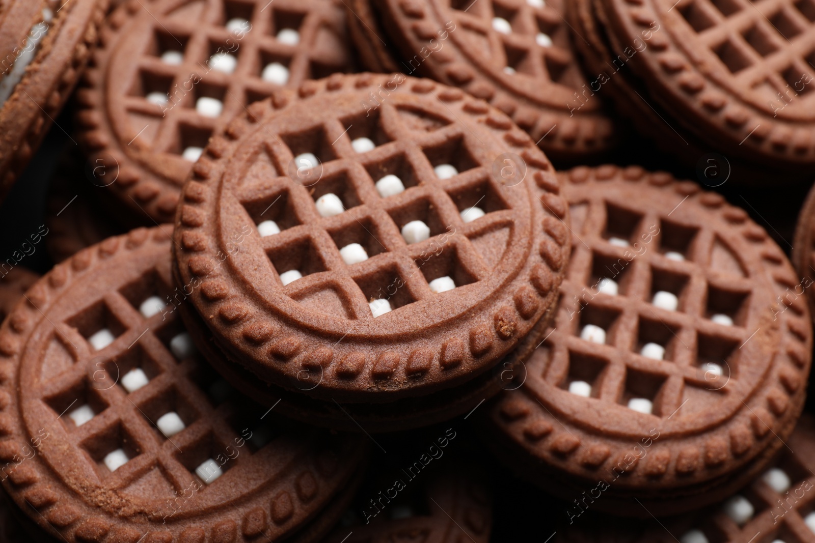 Photo of Tasty chocolate sandwich cookies with cream as background, closeup