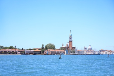 Photo of VENICE, ITALY - JUNE 13, 2019: Picturesque view of city with harbor and boats on seashore