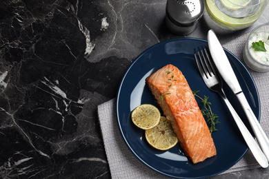 Photo of Flat lay composition with cooked red fish on dark marble table, space for text