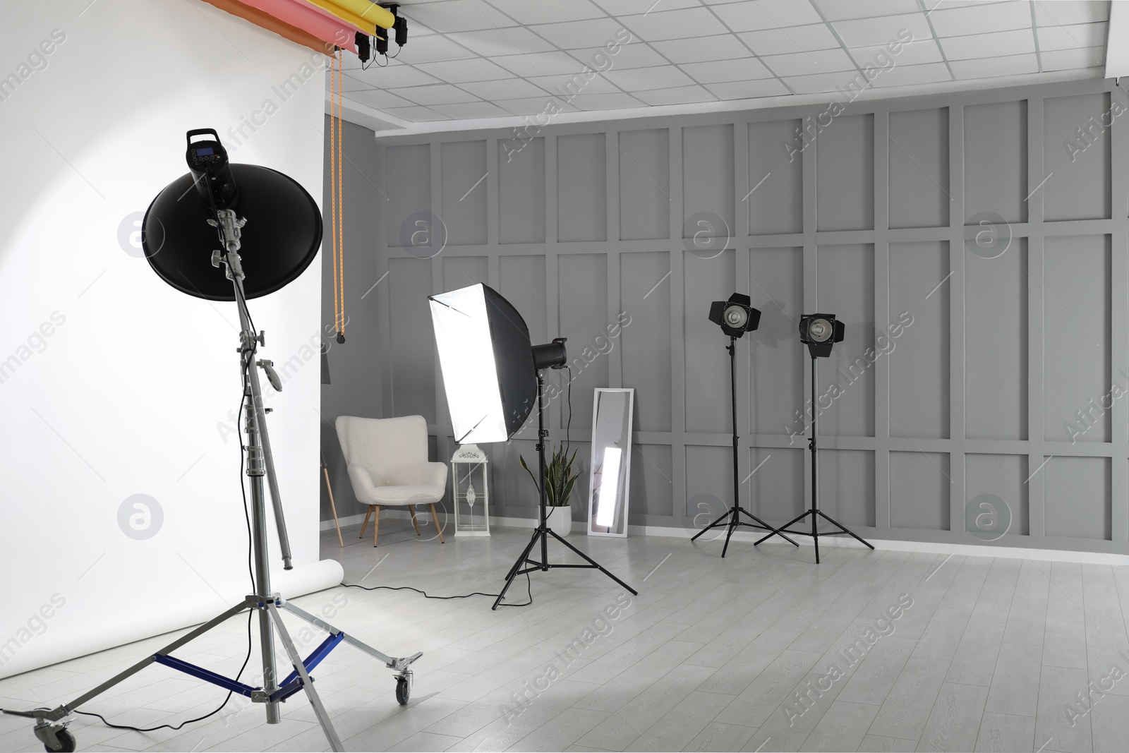 Photo of White photo background and professional lighting equipment in modern studio