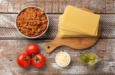 Photo of Flat lay composition with products for cooking lasagna on wooden rustic table