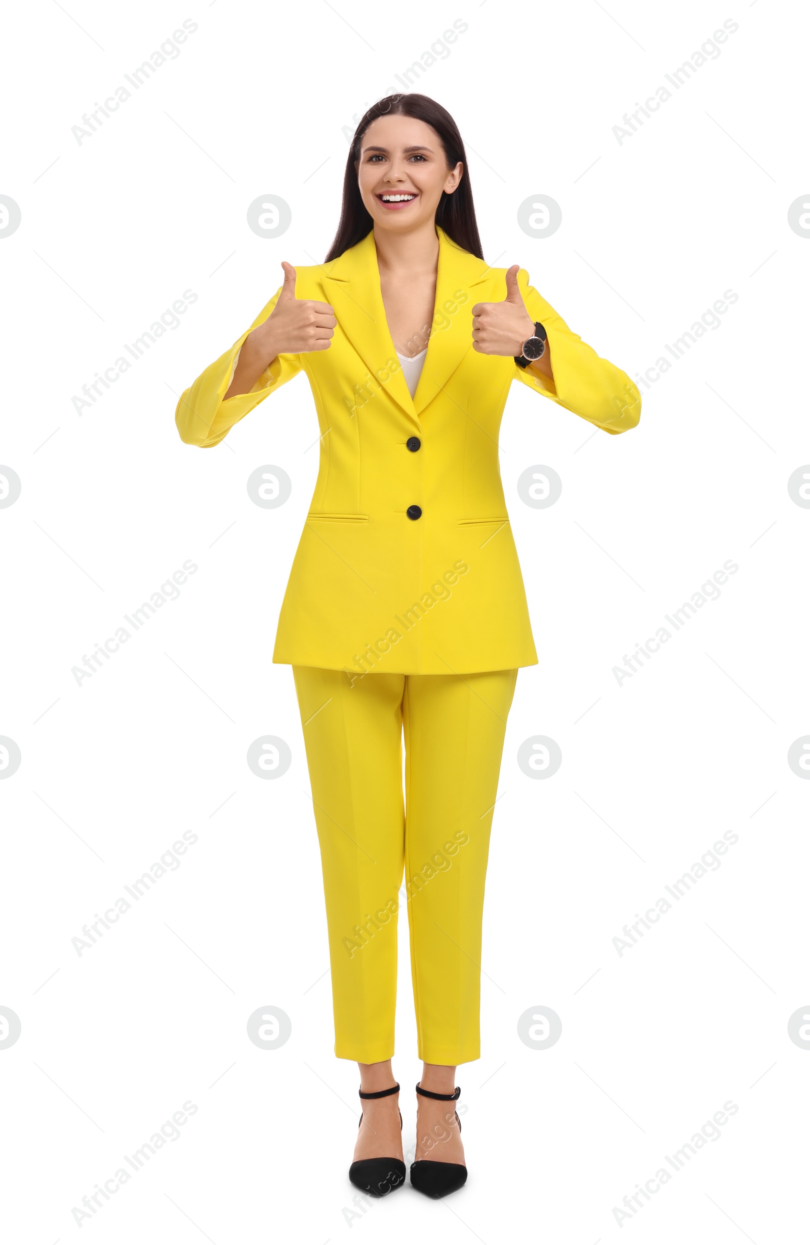 Photo of Beautiful happy businesswoman in yellow suit showing thumbs up on white background