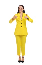 Photo of Beautiful happy businesswoman in yellow suit showing thumbs up on white background