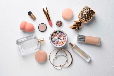 Flat lay composition with decorative cosmetics on light background