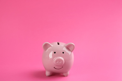 Photo of Cute piggy bank on bright pink background