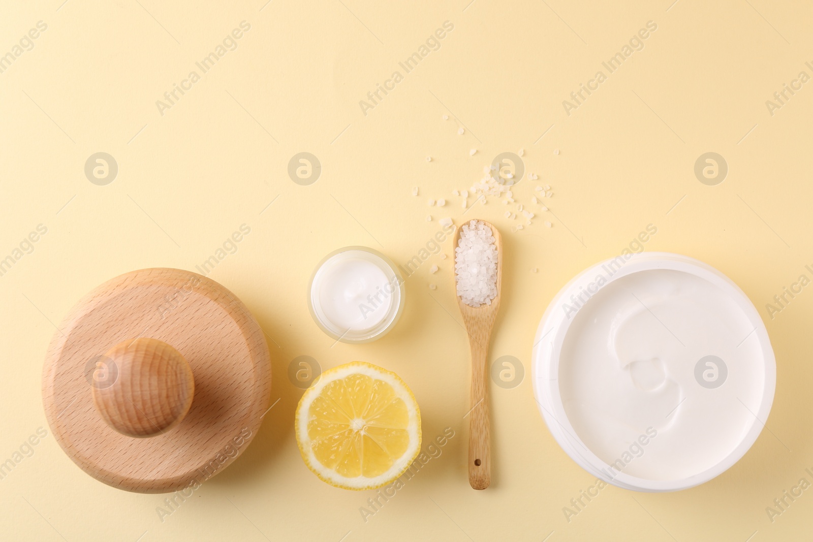 Photo of Flat lay composition with jars of cream on beige background, space for text