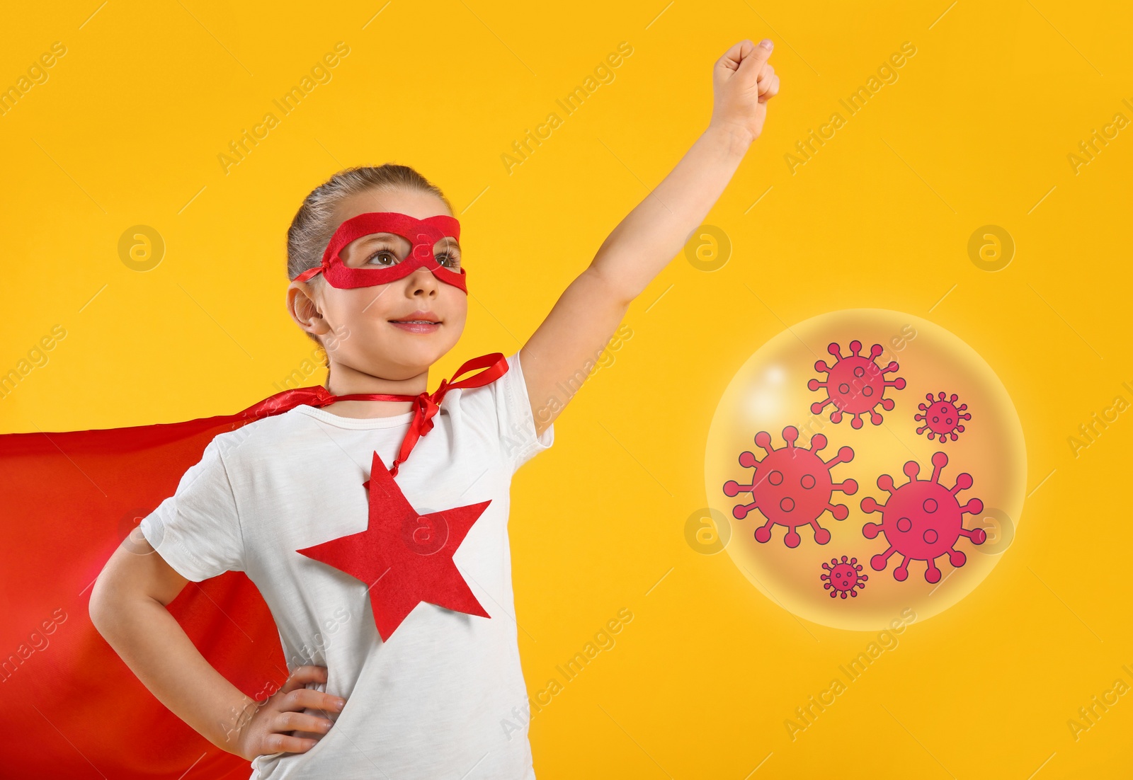 Image of Little girl wearing superhero costume fighting against viruses on yellow background