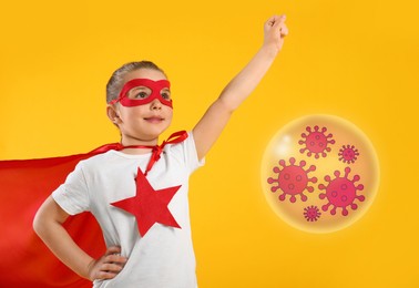 Image of Little girl wearing superhero costume fighting against viruses on yellow background