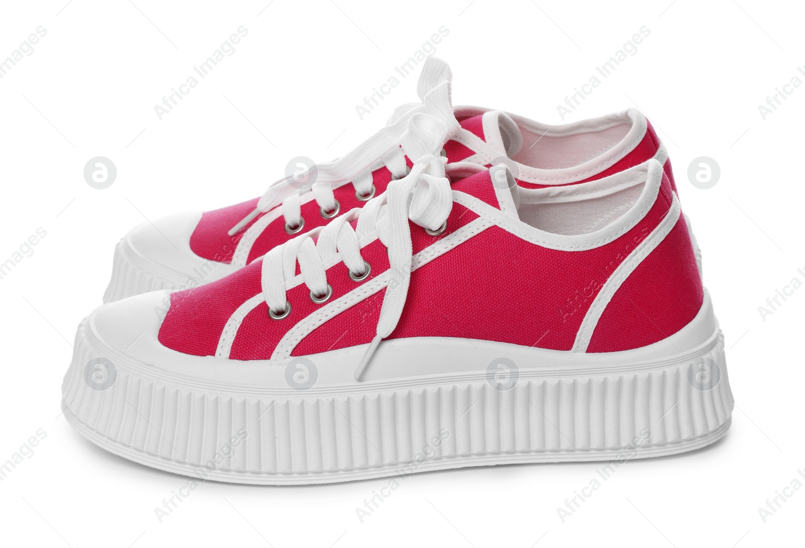 Photo of Pair of red classic old school sneakers on white background