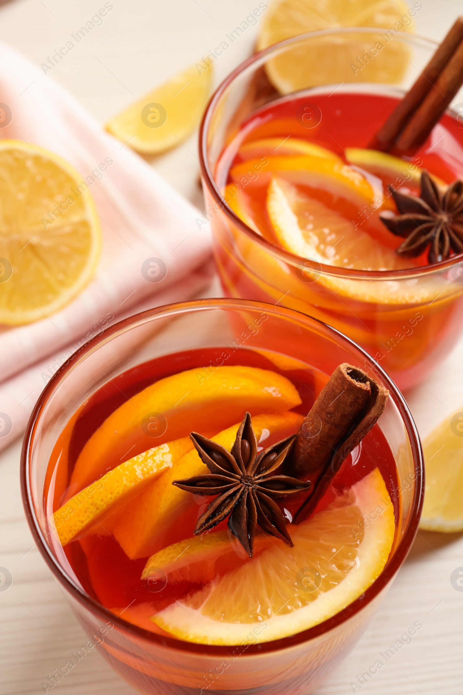 Photo of Aromatic punch drink and ingredients on white wooden table, above view