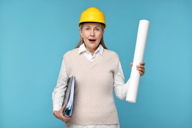 Architect in hard hat with draft and folder on light blue background