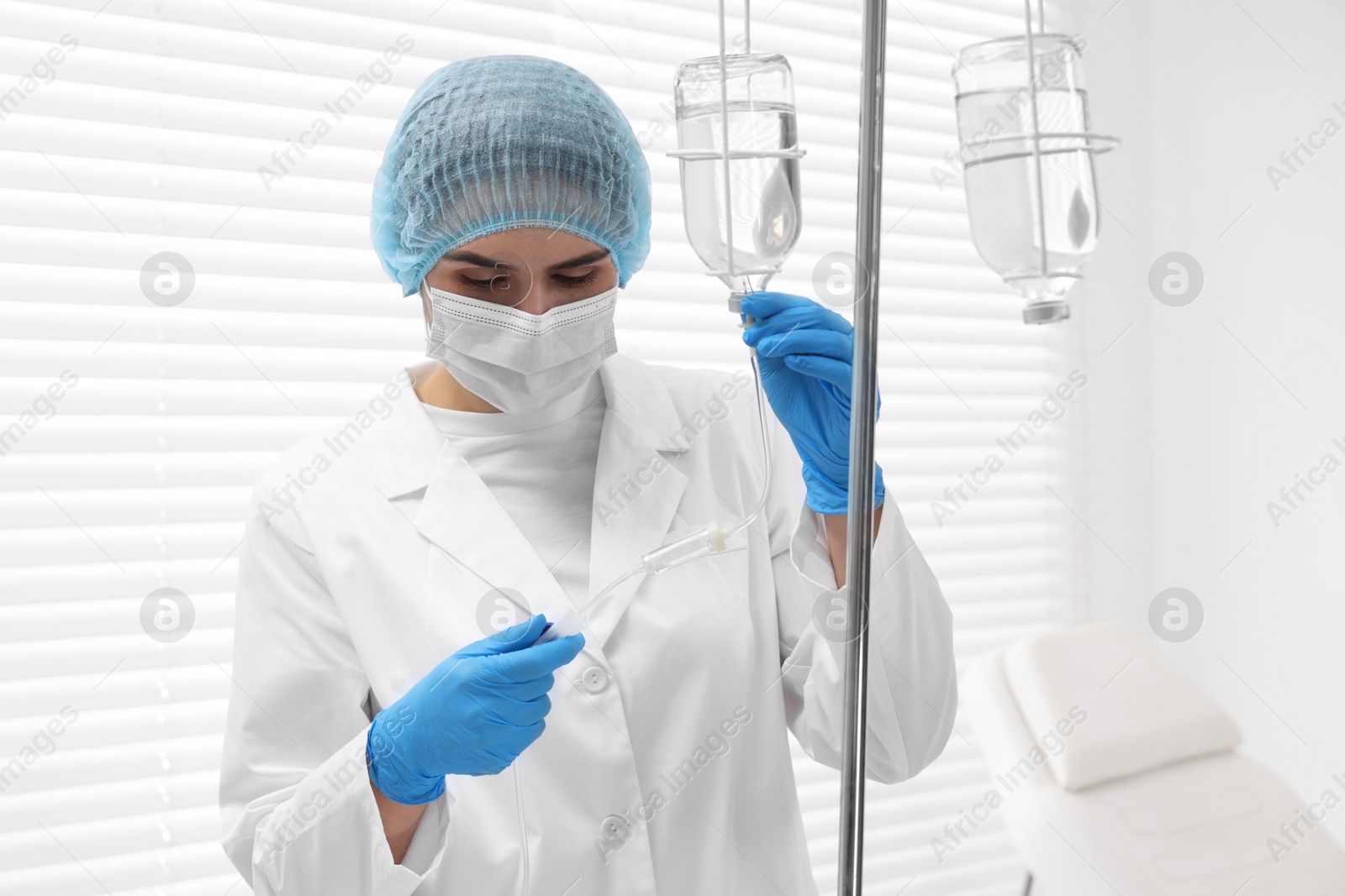 Photo of Nurse setting up IV drip in hospital