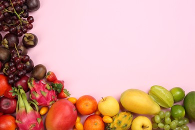 Assortment of fresh exotic fruits on pink background, flat lay. Space for text