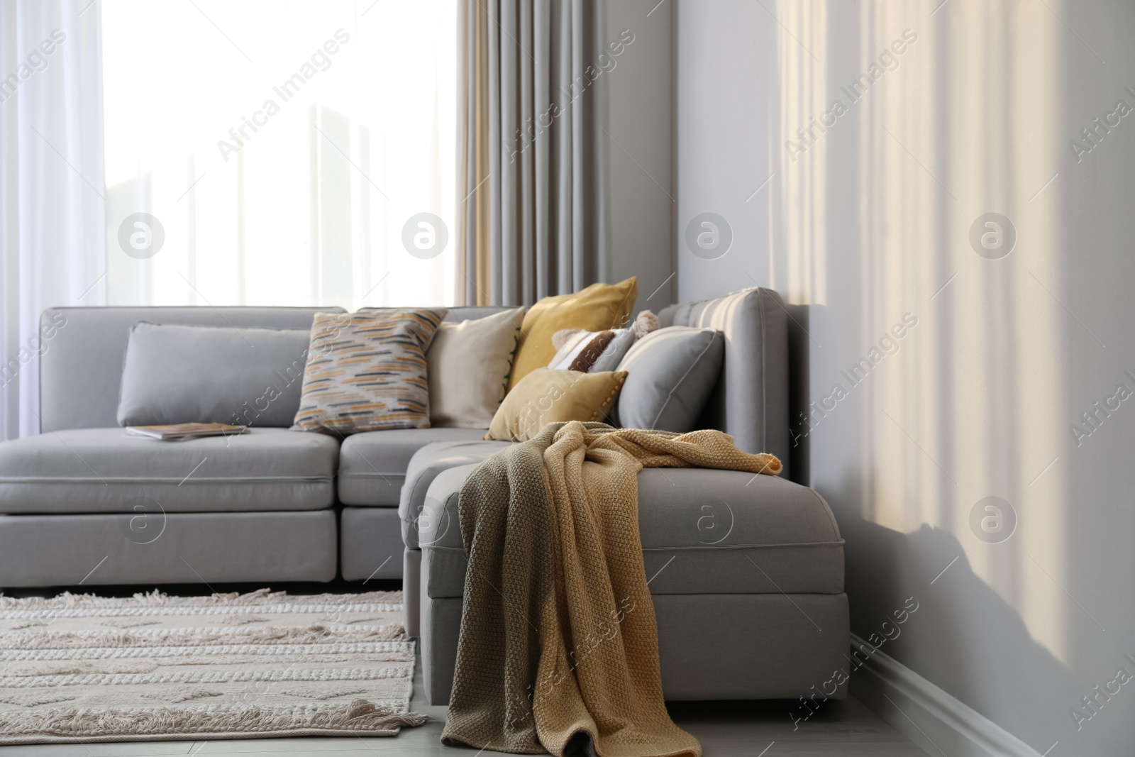 Photo of Large grey sofa in living room. Interior design