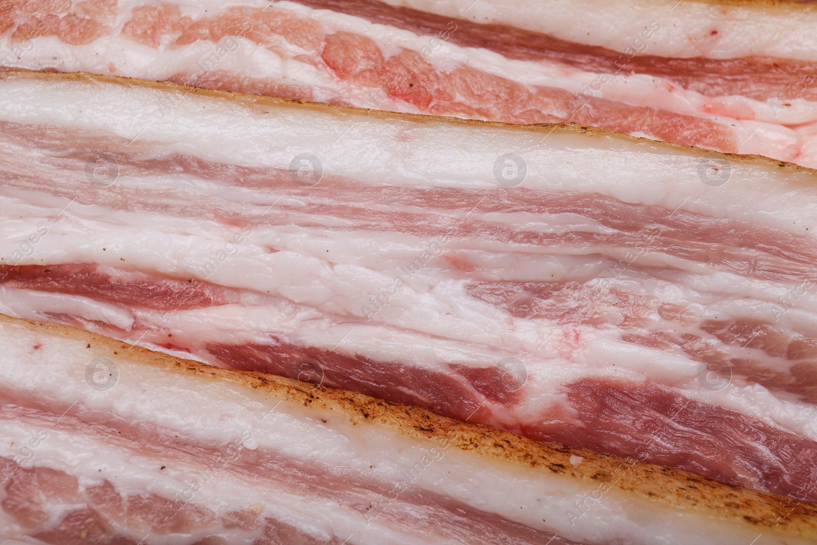 Photo of Tasty pork fatback slices as background, closeup