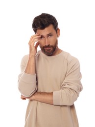 Embarrassed man covering face with hand on white background