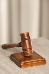 Photo of Law concept. Gavel on wooden table, closeup. Space for text