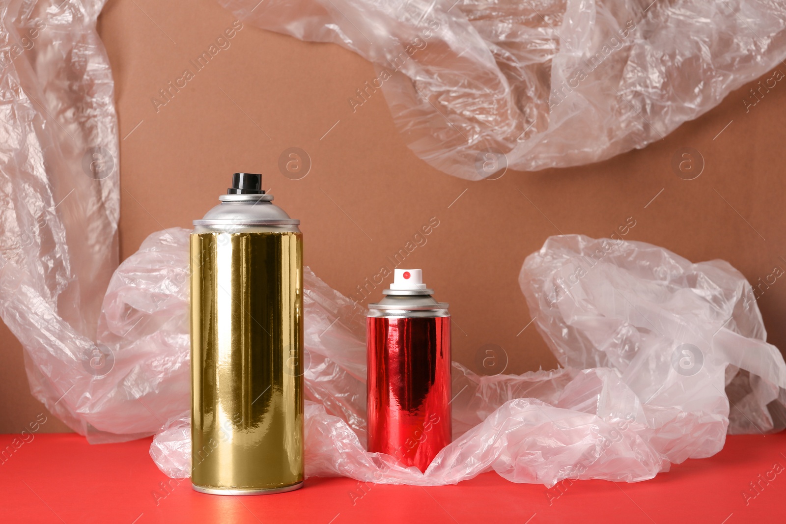 Photo of Different cans of spray paints on color background. Space for text