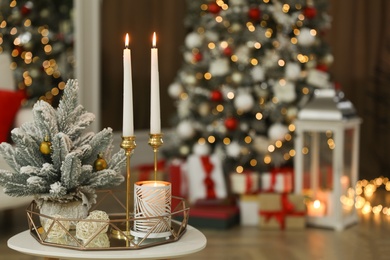 Photo of Beautiful Christmas composition with burning candles on table indoors