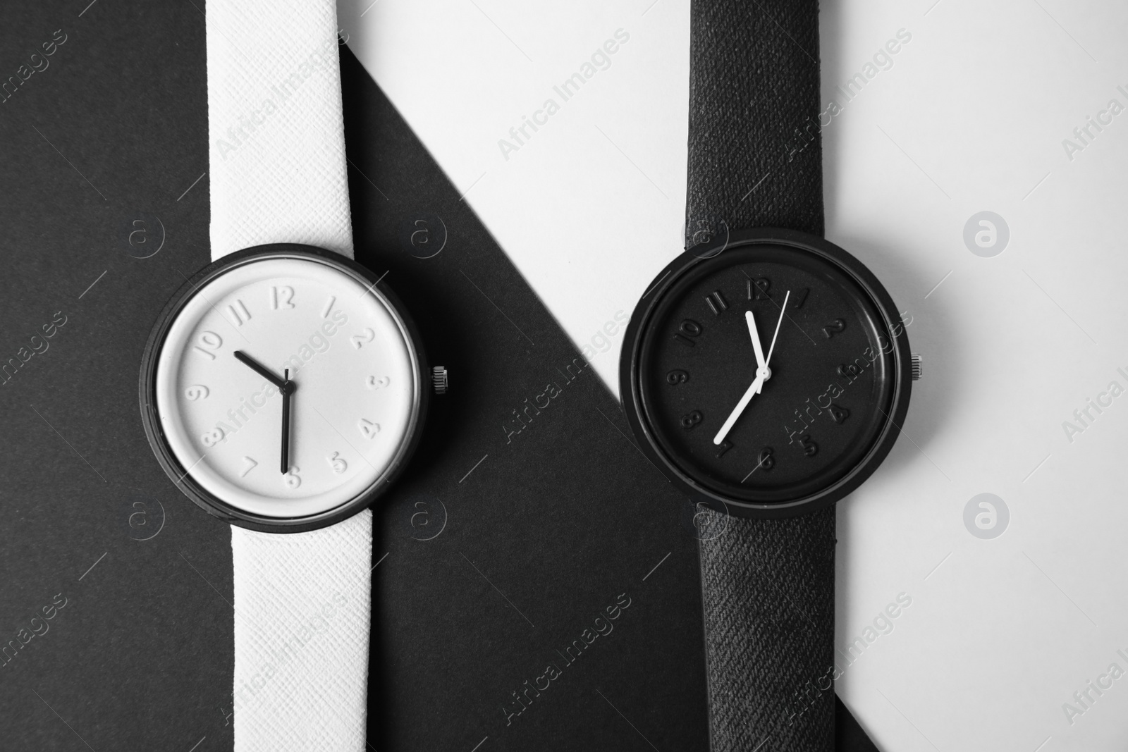 Photo of Composition with stylish wrist watches on color background, flat lay. Fashion accessory