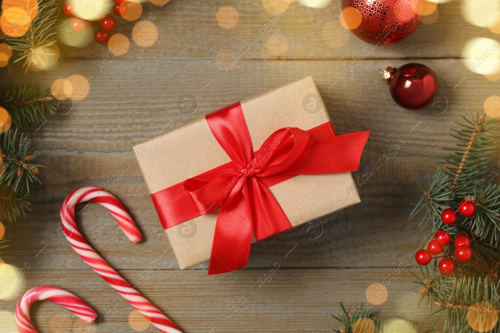 Photo of Flat lay composition with Christmas gift box and decor on wooden table