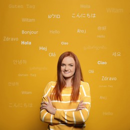 Image of Portrait of happy translator and greeting words in different foreign languages on orange background