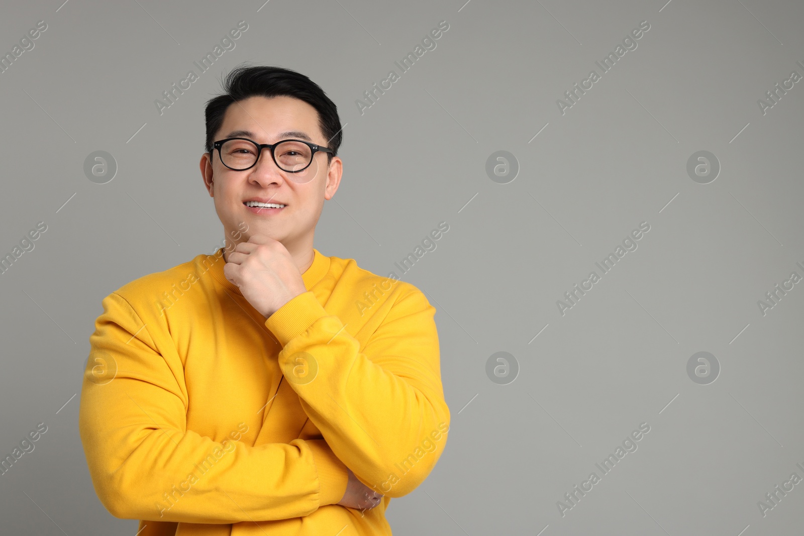 Photo of Portrait of happy man on grey background. Space for text