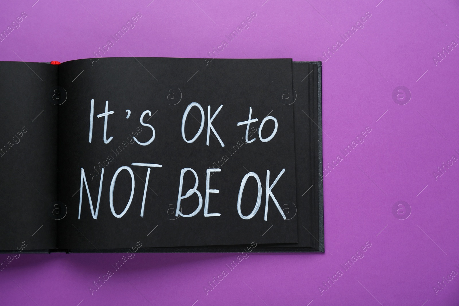 Photo of Notebook with phrase It`s Ok To Not Be Ok on purple background, top view