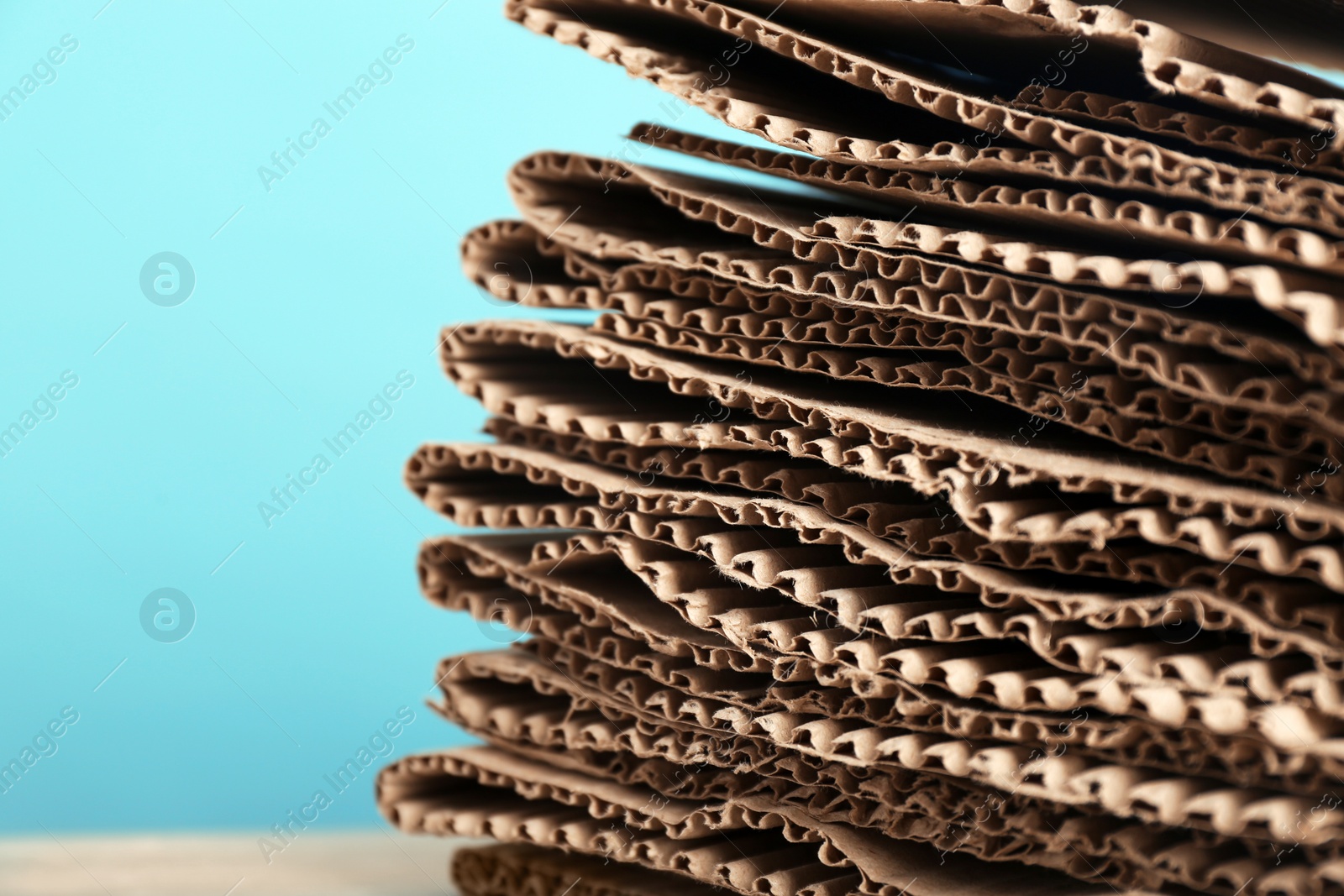 Photo of Stack of cardboard for recycling on color background, closeup