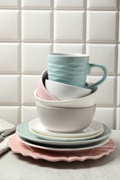 Photo of Beautiful ceramic dishware and cup on light grey table