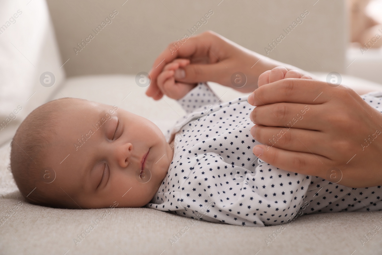 Photo of Mother with her cute sleeping baby at home, closeup