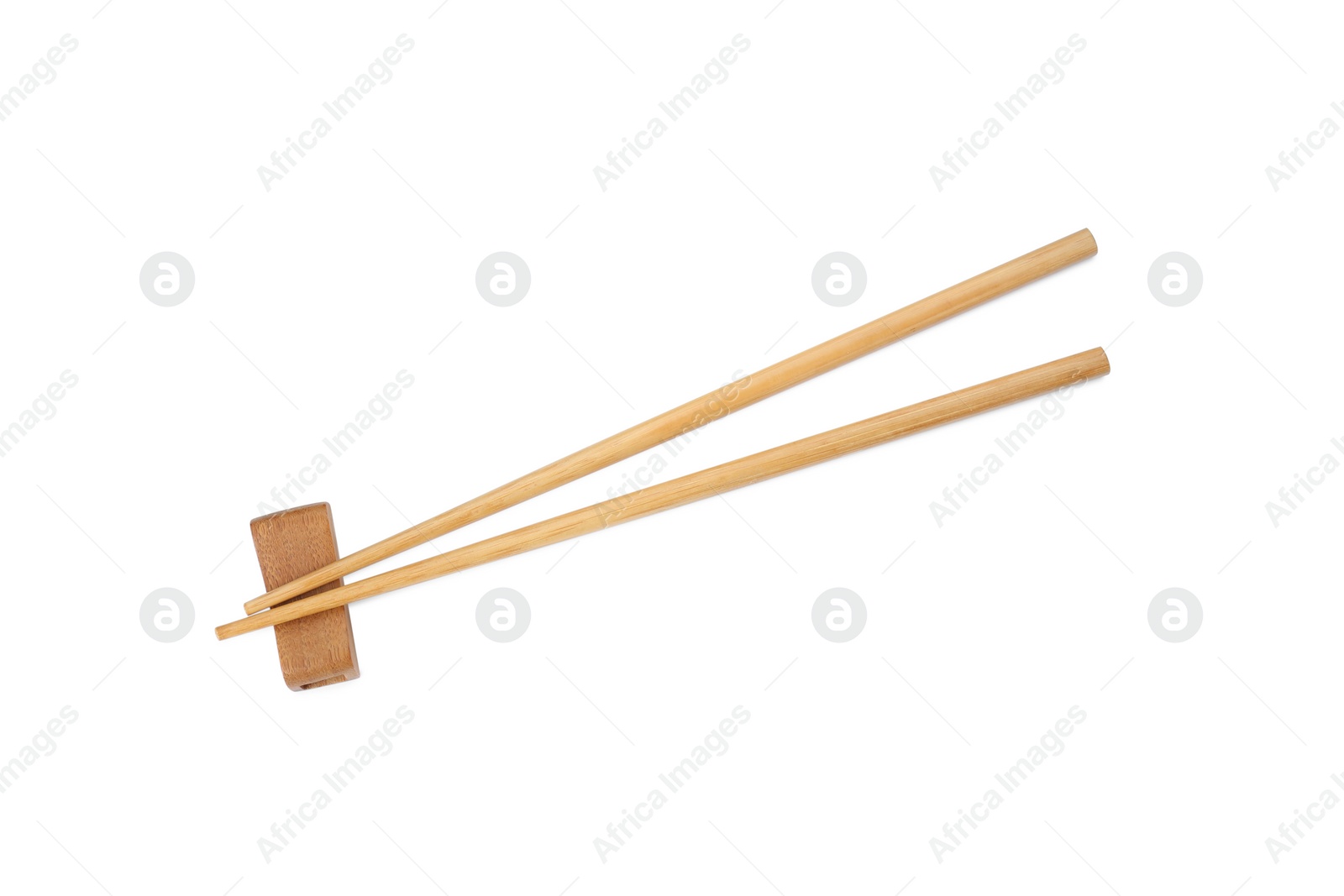 Photo of Pair of wooden chopsticks with rest isolated on white, top view