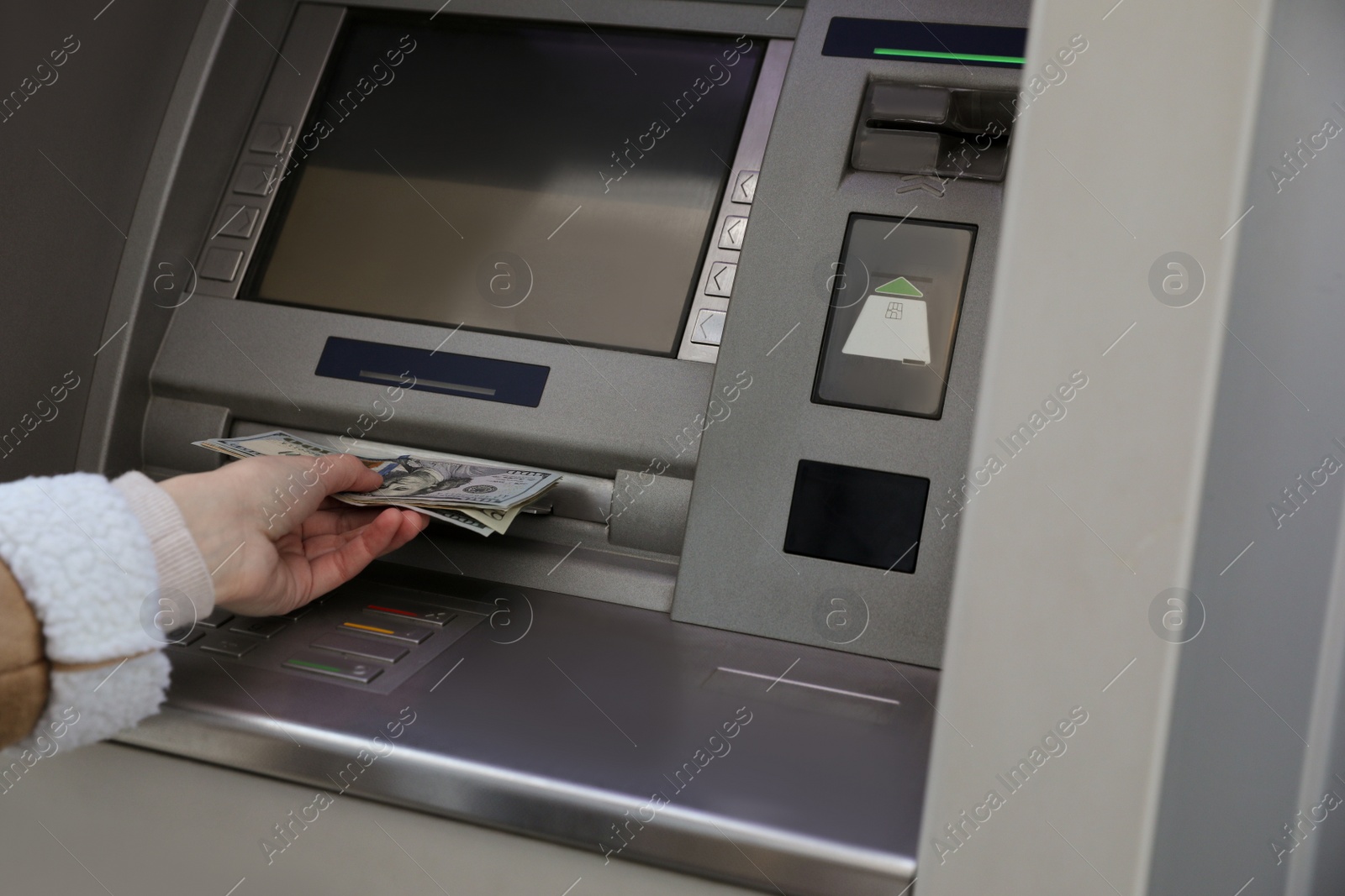 Photo of Woman using cash machine for money withdrawal, closeup