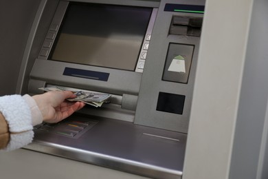 Photo of Woman using cash machine for money withdrawal, closeup