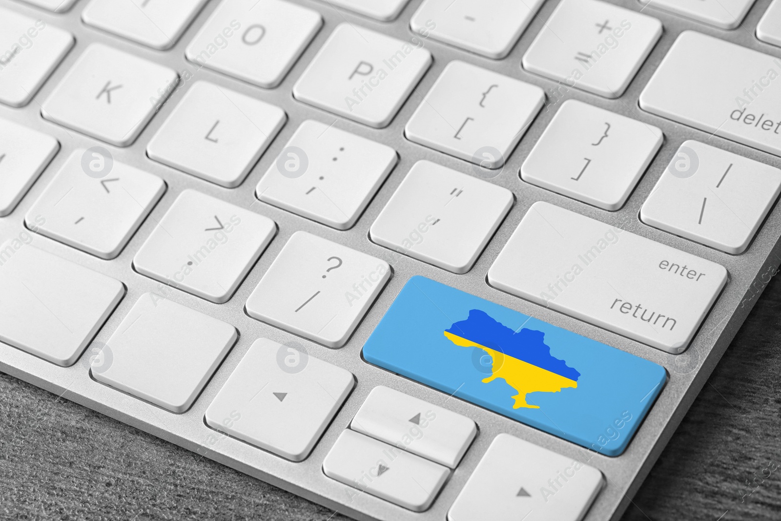 Image of Button with map of Ukraine in colors of national flag on keyboard, closeup view