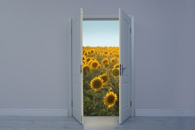 Image of Beautiful sunflower field visible through open door