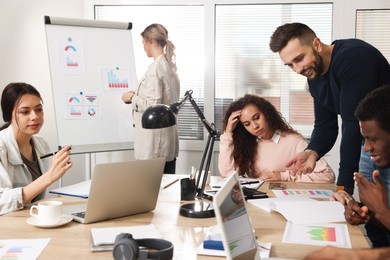 Photo of Team of employees working together in office. Startup project