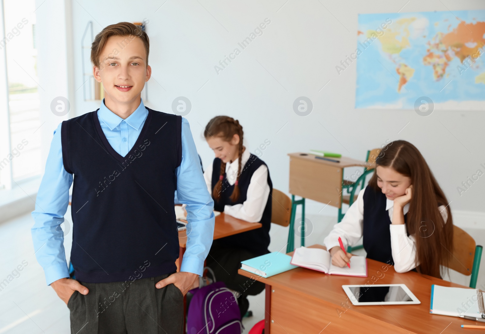 Photo of Teenage student in classroom. Stylish school uniform