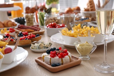 Photo of Variety of snacks on wooden table in buffet style