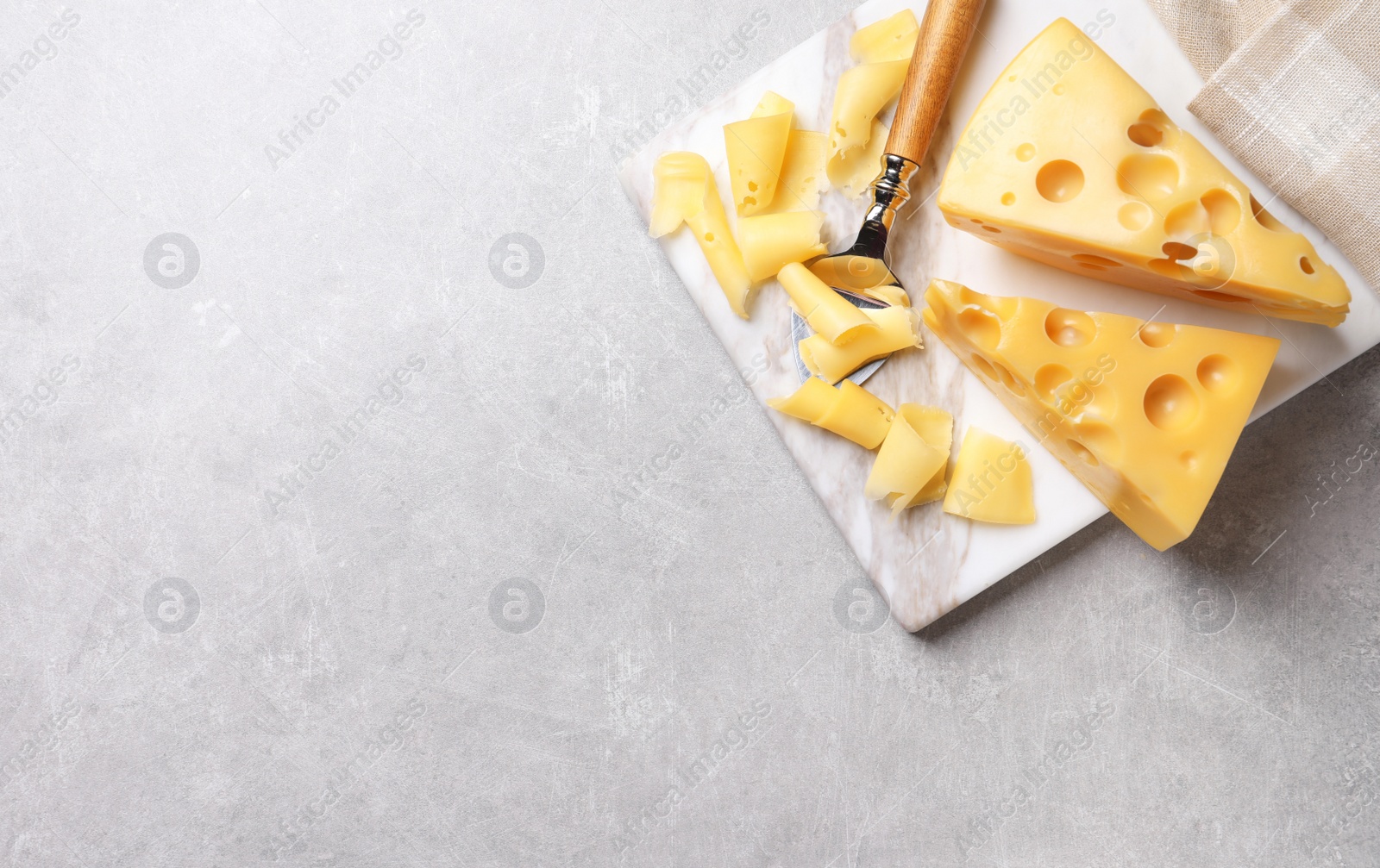 Photo of Tasty fresh cheese on light grey table, top view. Space for text