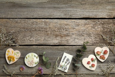 Flat lay composition with scented sachets on wooden table