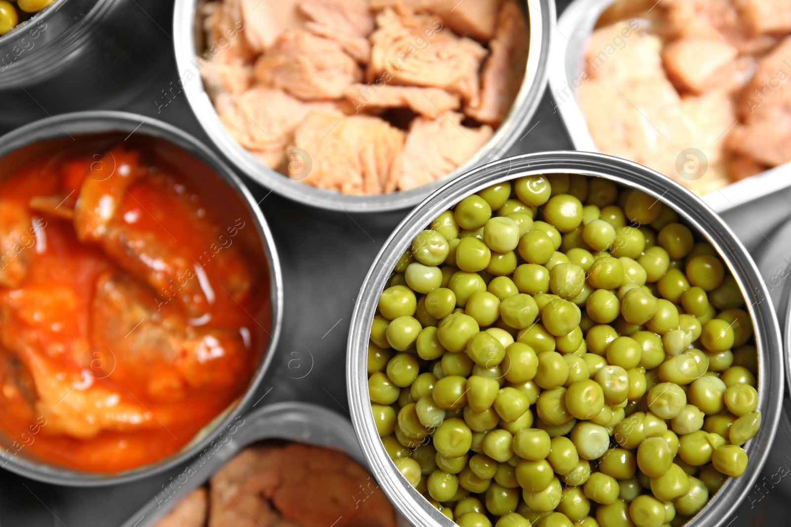 Photo of Open tin cans of conserved products, top view