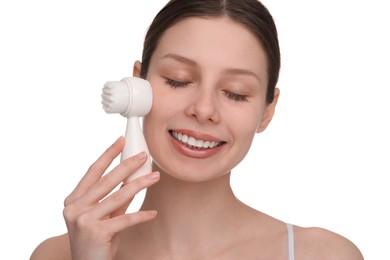 Photo of Washing face. Young woman with cleansing brush on white background