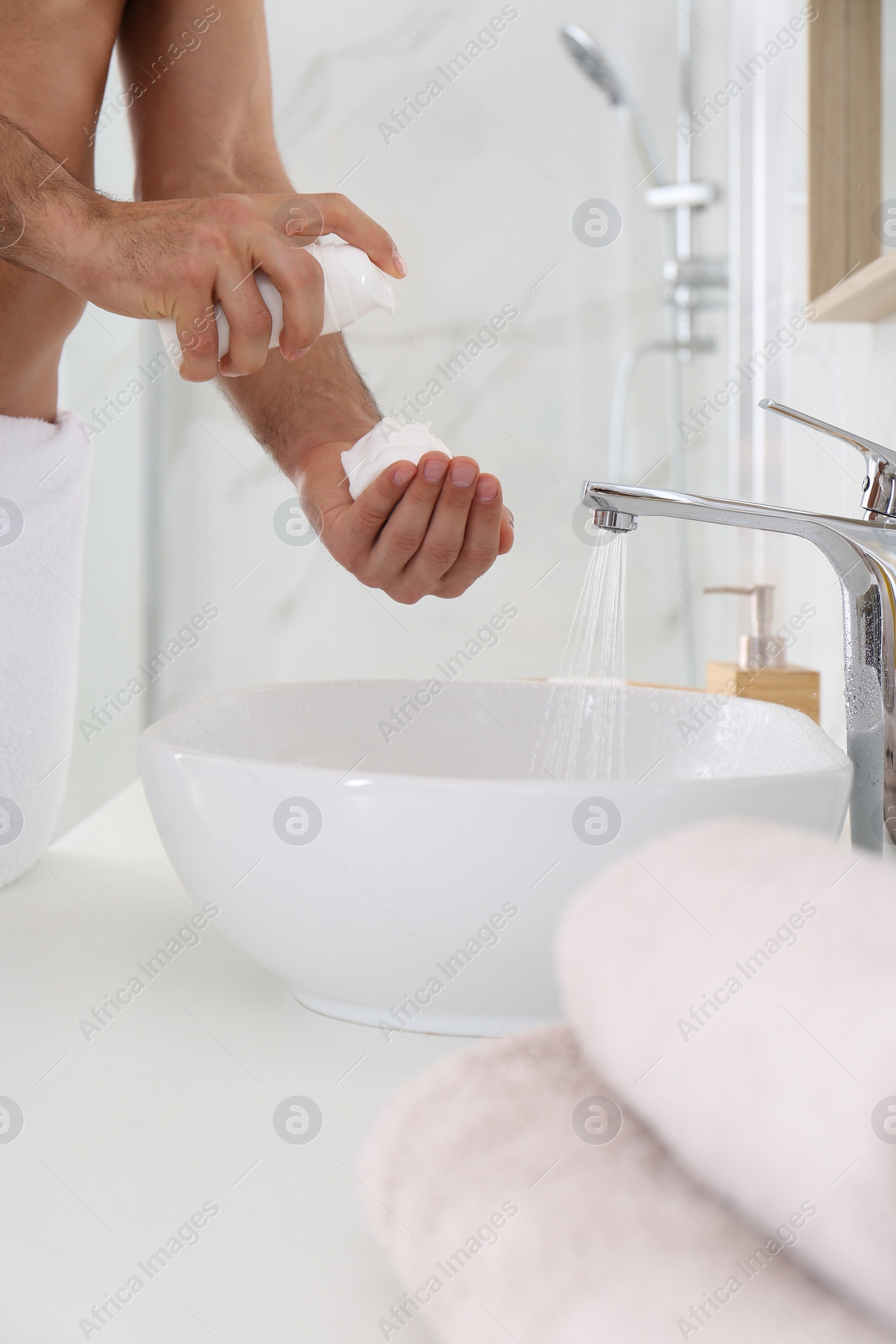 Photo of Man with shaving foam in bathroom, closeup