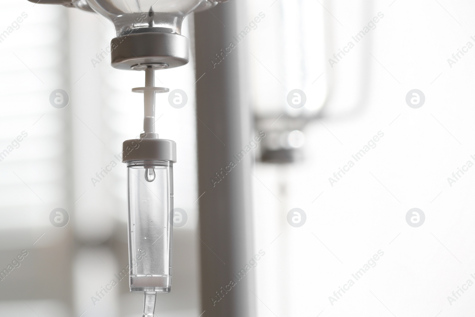 Photo of IV drip against blurred background, space for text