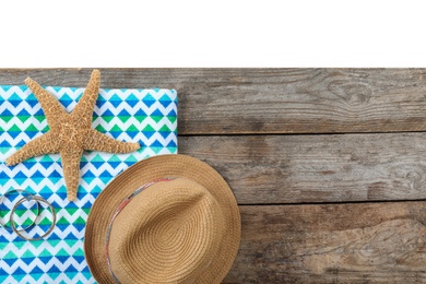 Flat lay composition with beach accessories on wooden background. Space for text