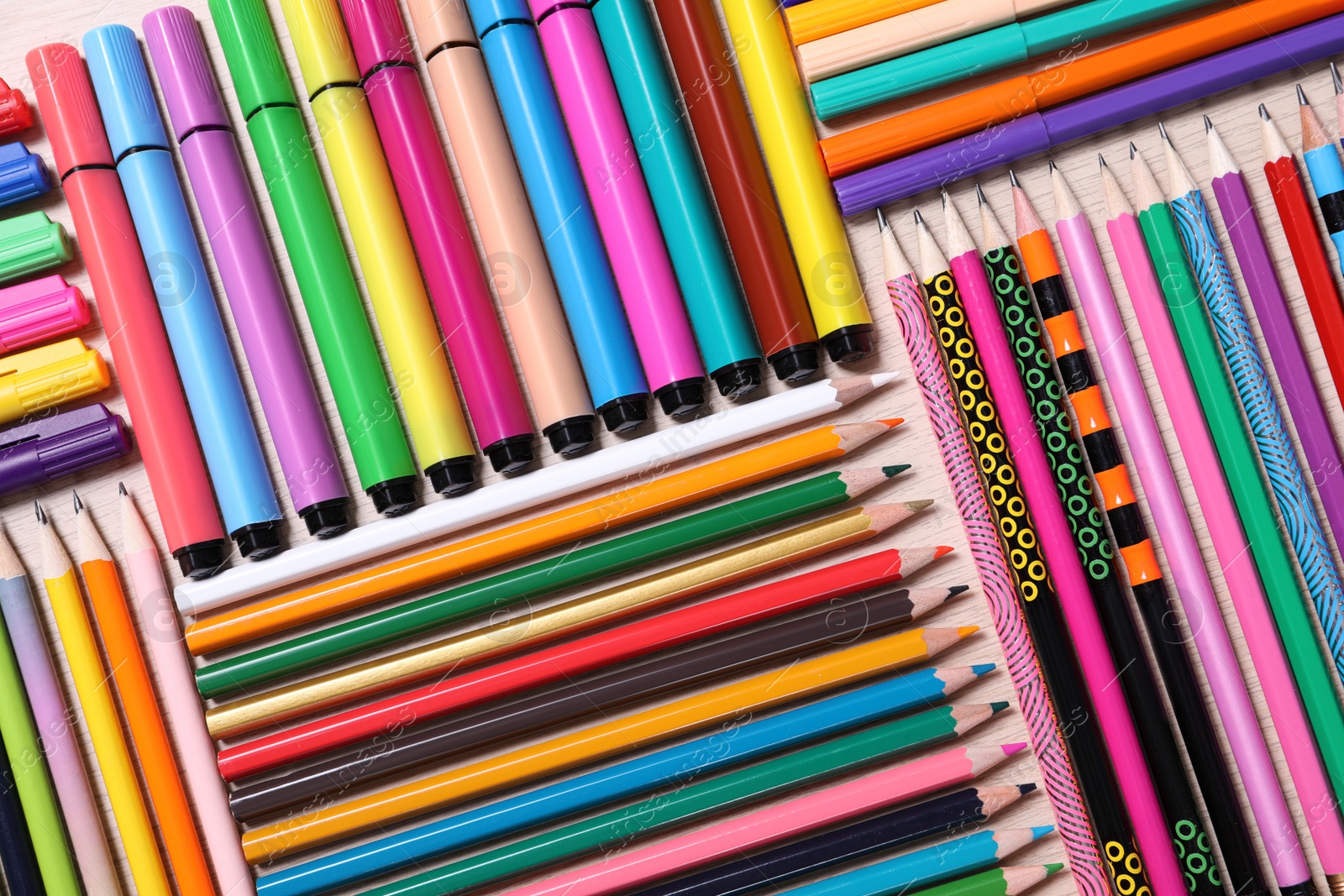 Photo of Different school stationery on wooden table, flat lay