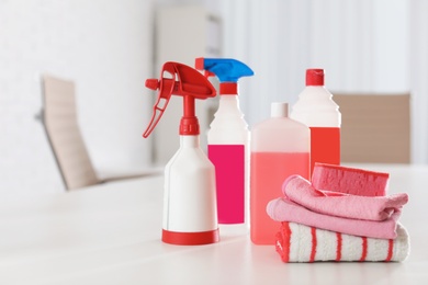 Set of professional cleaning supplies on table indoors. Space for text